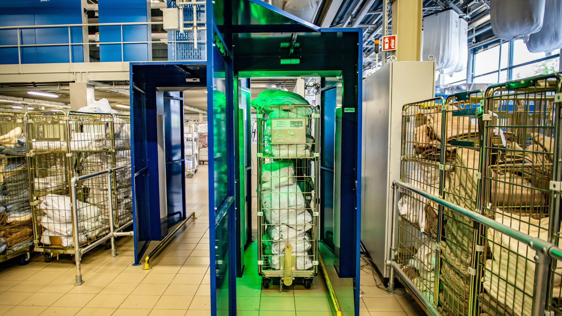 Rolling containers in an industrial laundry
